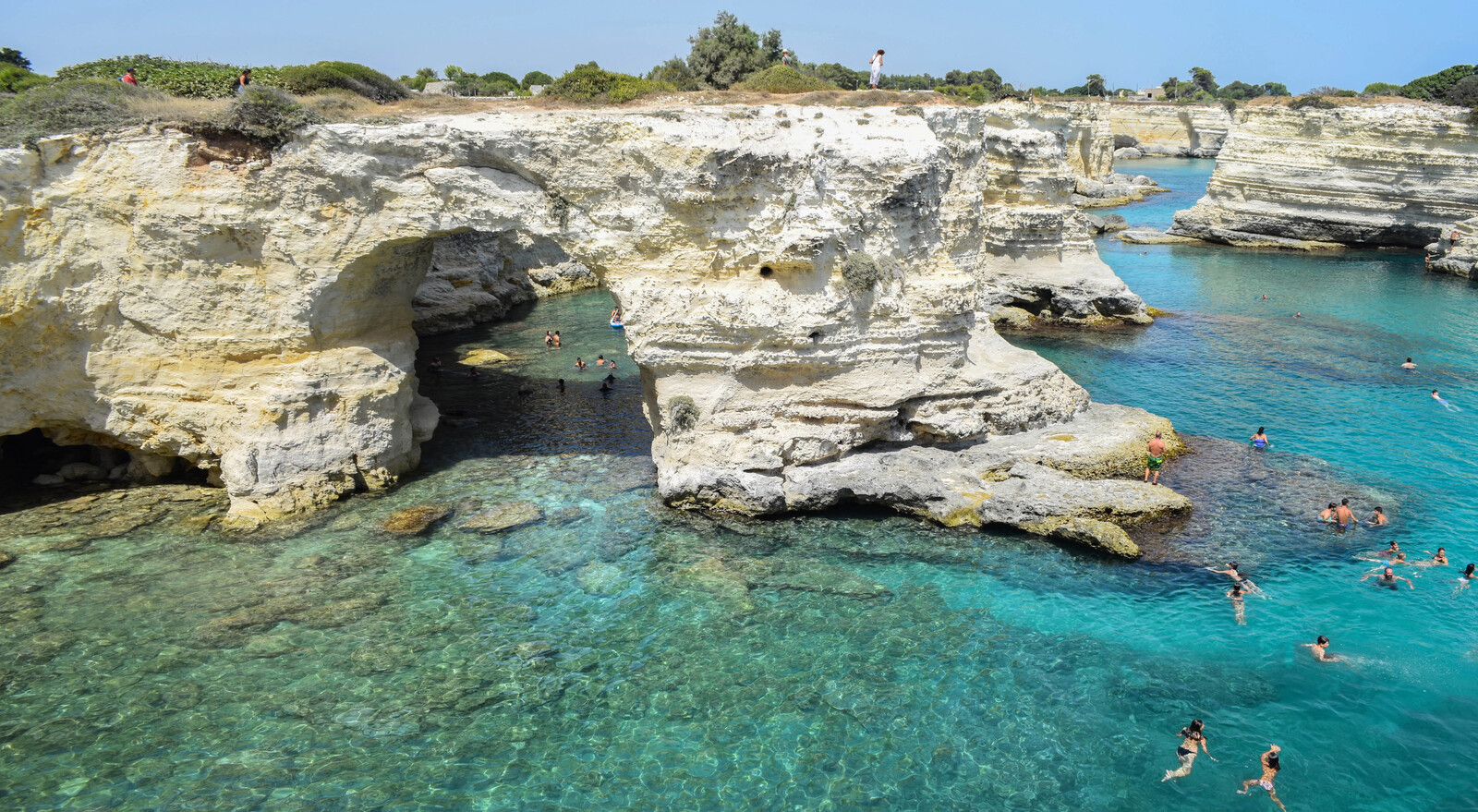 Turquoise cove and rock arch along the Southern Italian coast