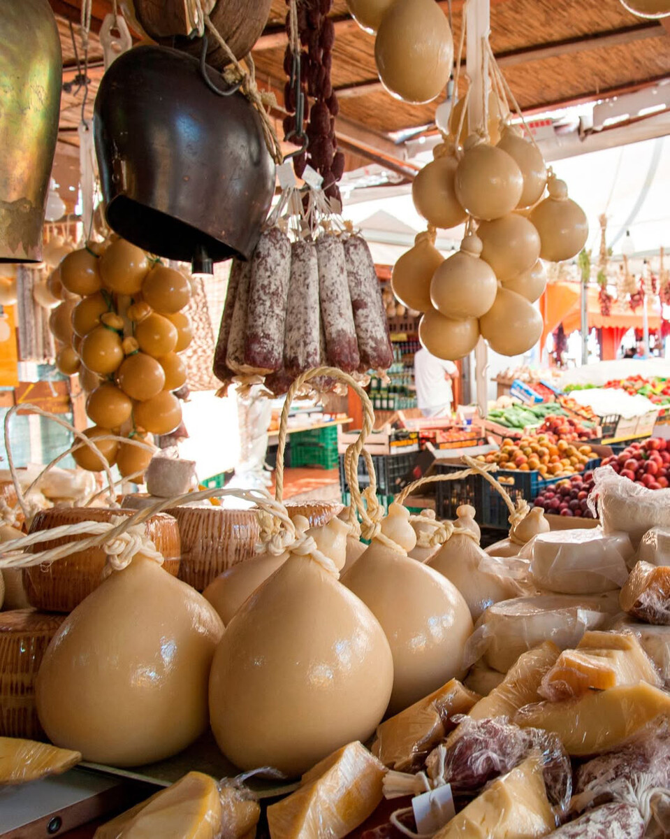 Traditional Puglian cheeses and cured meats on display at a local market