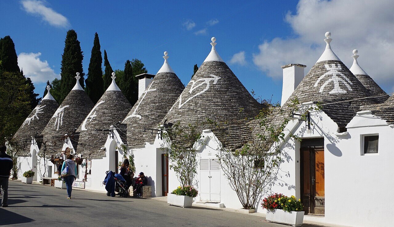 Street in Alberobello lined with traditional whitewashed trulli houses