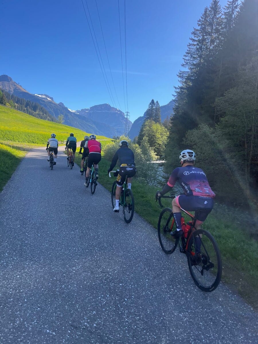 Group of cyclists riding a mountain road in the Dolomites