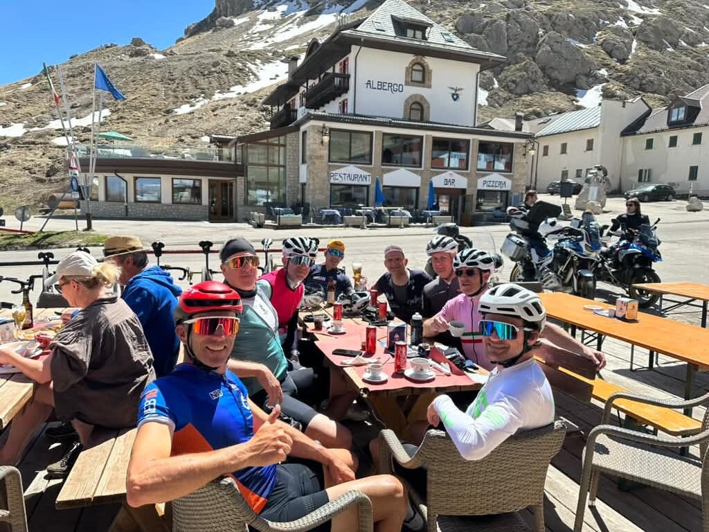 Group of cyclists having lunch at a mountain pass hotel