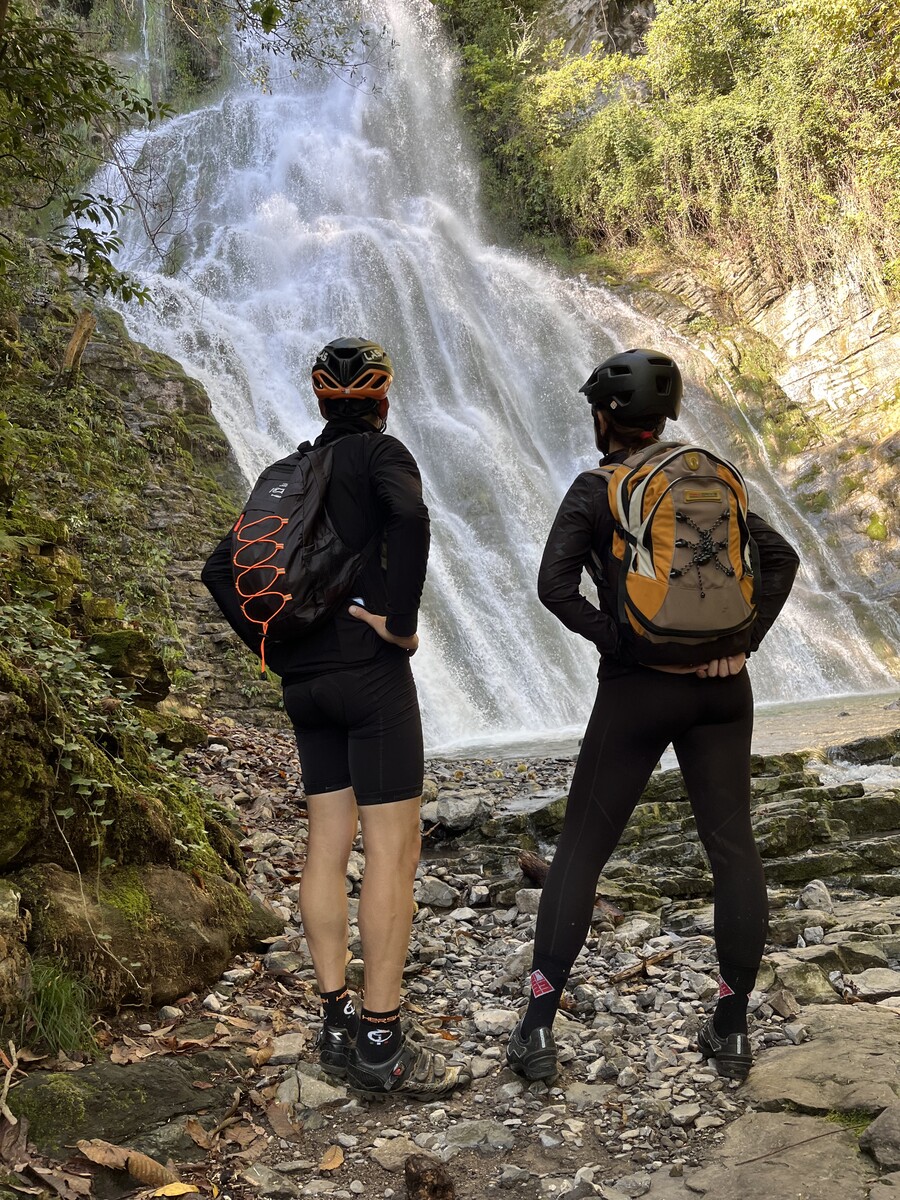 Cyclists stopping at the waterfall near Laglio on Lake Como