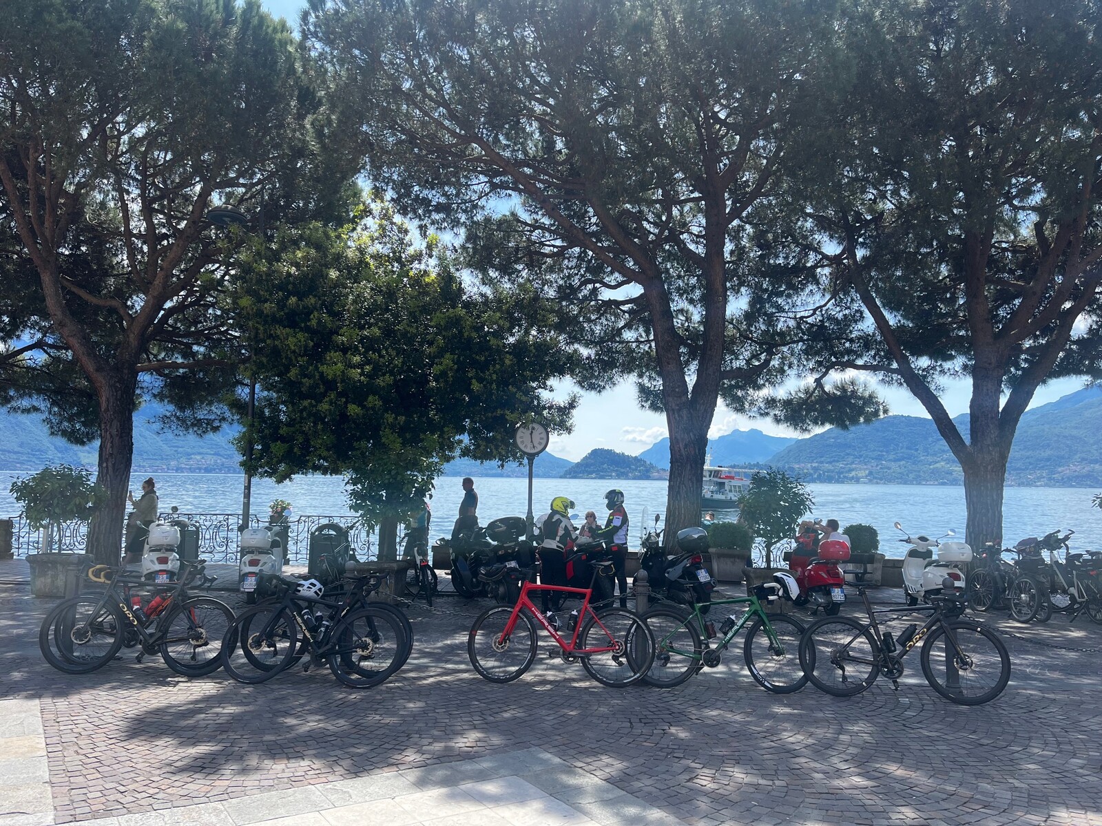 Road bikes parked in a shaded piazza in Bellagio