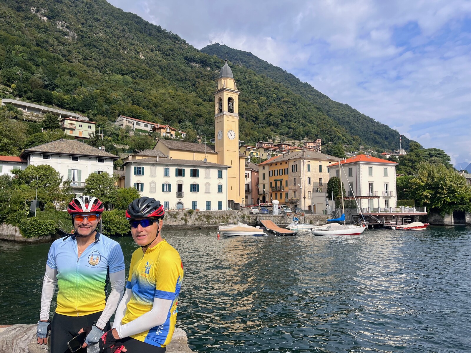 Two road cyclists posing by the lake in Bellagio