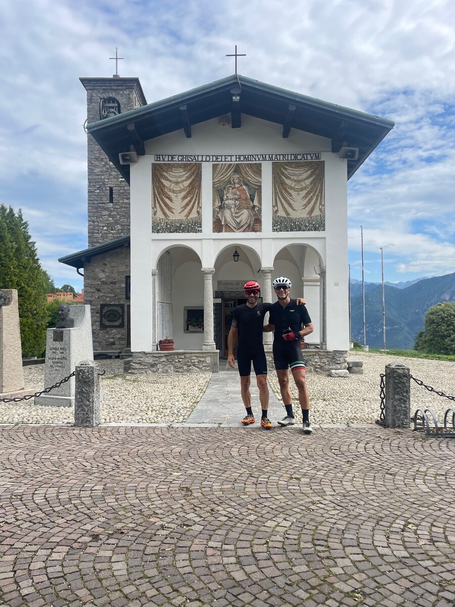 Madonna del Ghisallo sanctuary with cyclists nearby