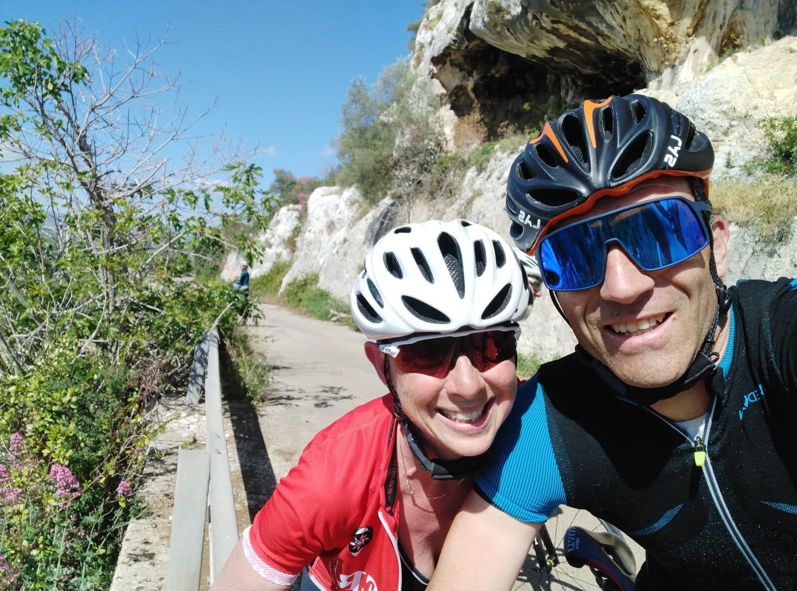 Two cyclists taking a selfie along a scenic natural trail