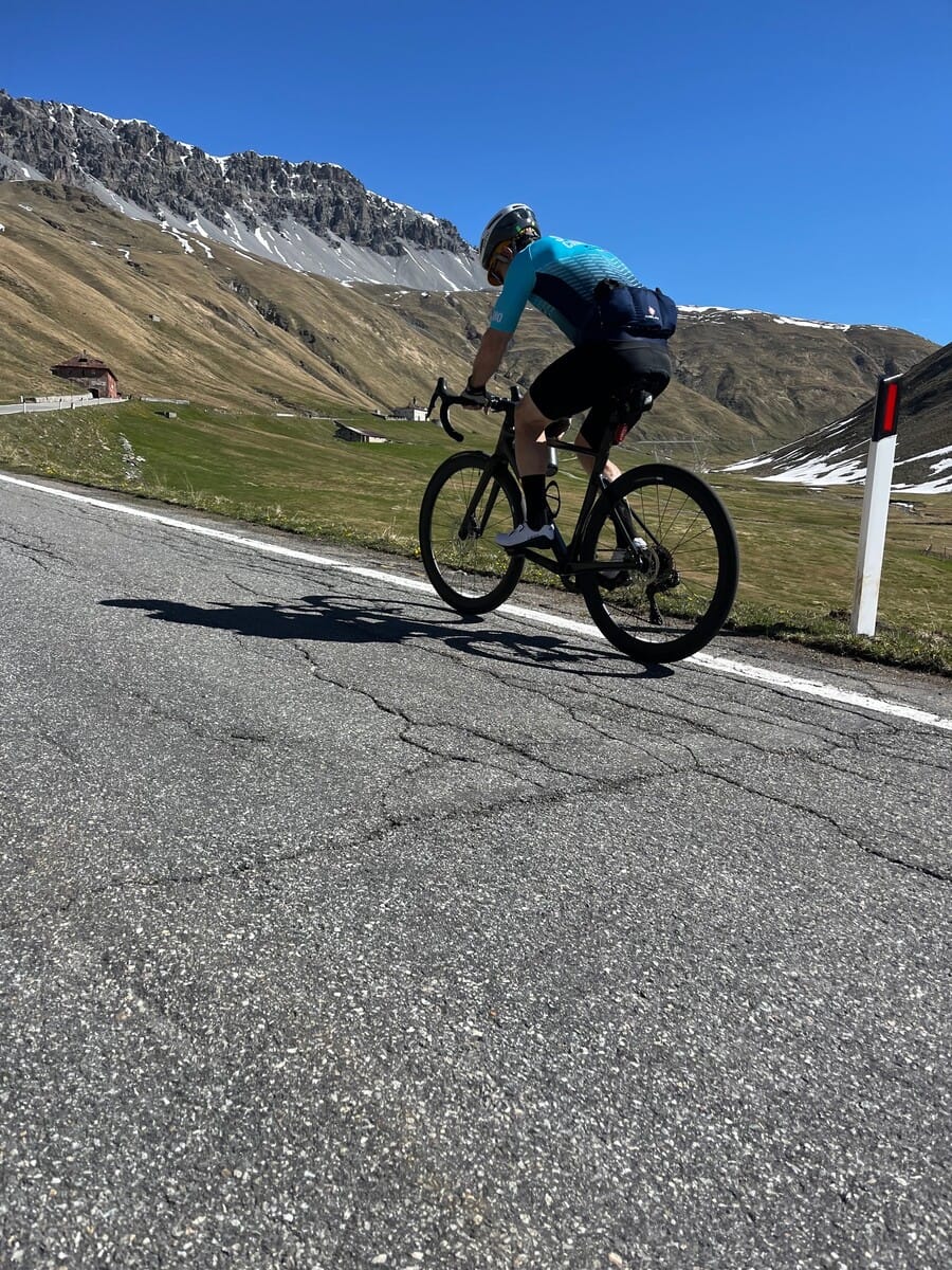 Cyclist celebrating on the hairpin turns of the Stelvio Pass