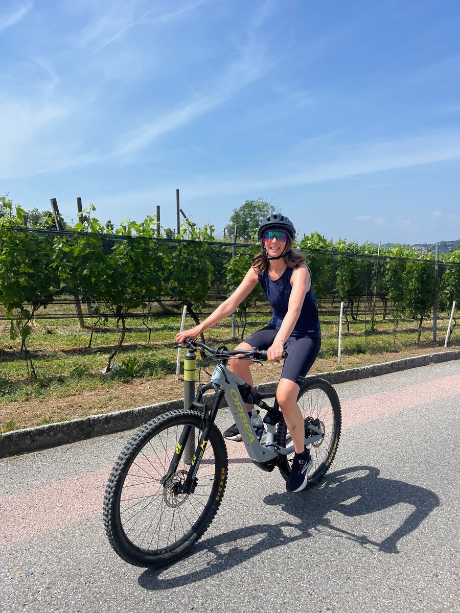 Cyclist riding a gravel path through the vineyards